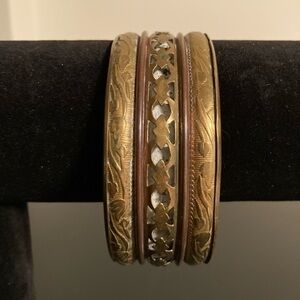 Golden and brown bracelet with carved floral patterns and cut outs